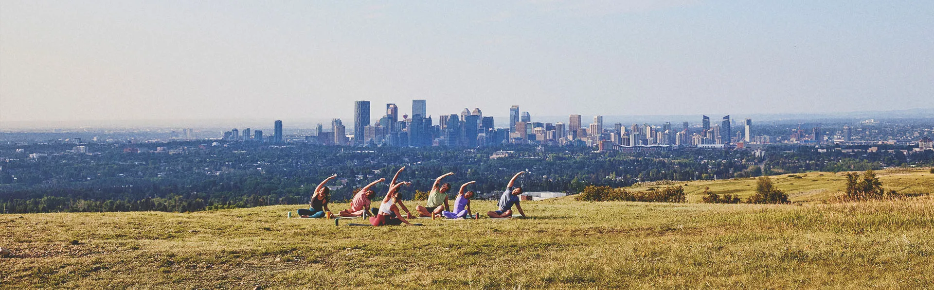 a group of people practicing yoga at Nose Hill park