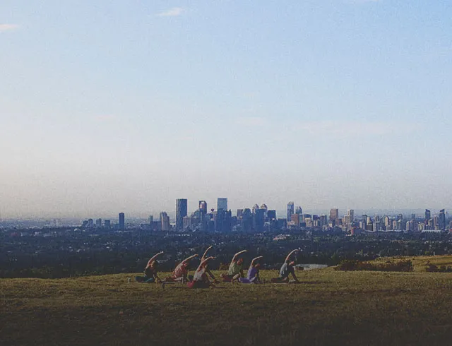 a group of people practicing yoga at Nose Hill park