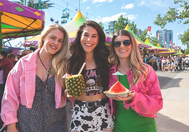 a group of friends sharing some fresh options on the midway at Calgary Stampede