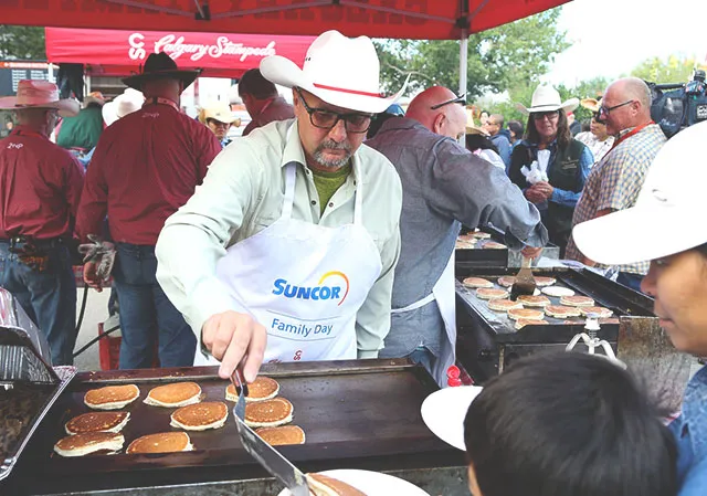 A man serving classic Calgary Stampede pancake breakfast