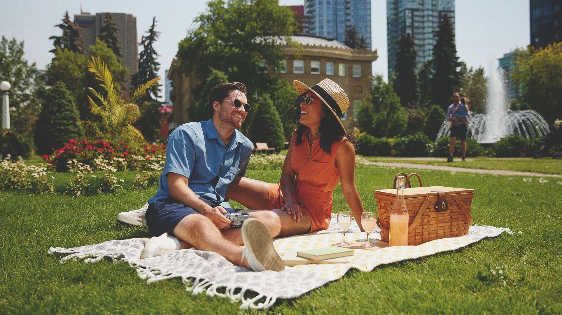 couple laughing and enjoying picnic at Central Memorial Park in Calgary