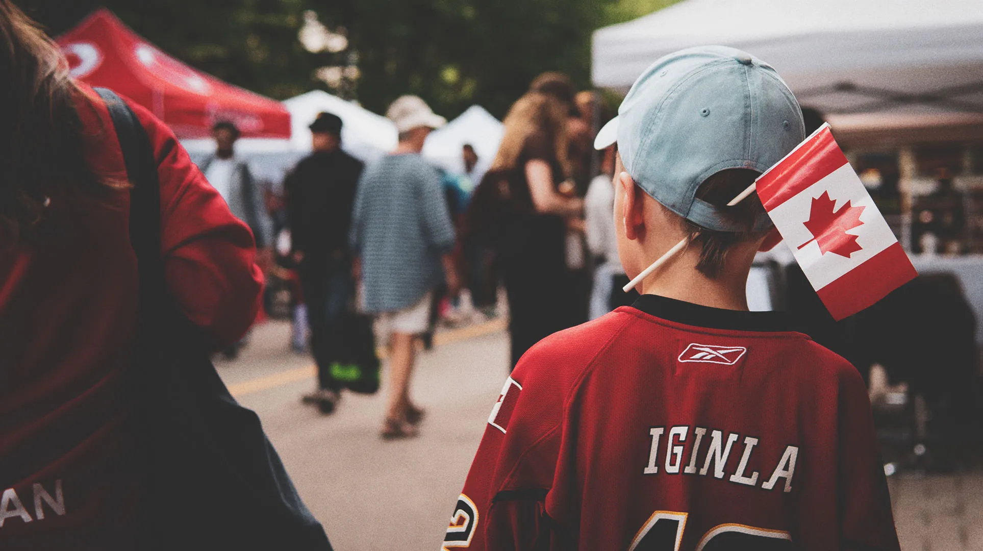 A little boy with a Canadian flag celebrating Canada Day