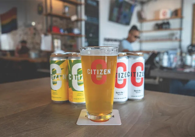 Pints and to-go cans on the bar at Citizen Brewing